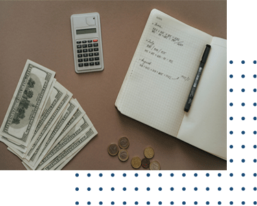 A calculator, pen and notebook with money on the table.